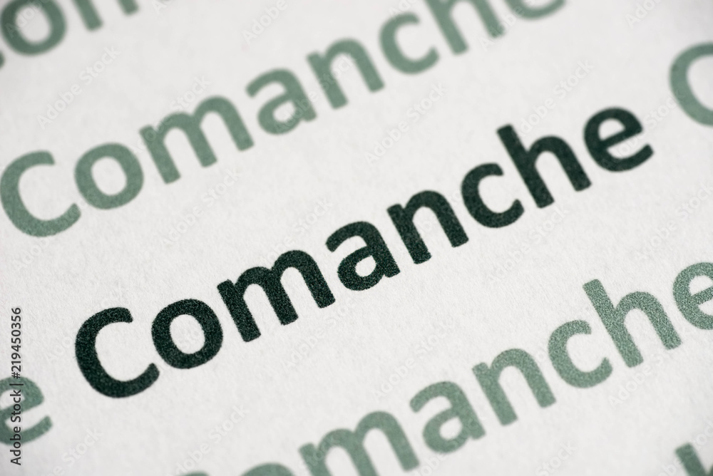 Fototapeta premium word Comanche language printed on paper macro