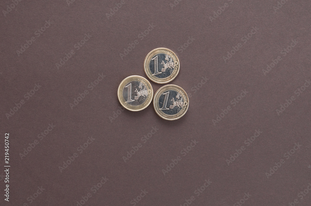three coins in one Euro on a dark background top view three coins in one Euro on a dark background top view