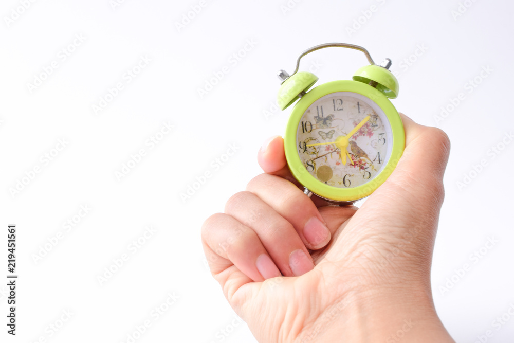 hand with alarm clock isolated against white background, time management concept. hand with alarm clock isolated against white background, time management concept.