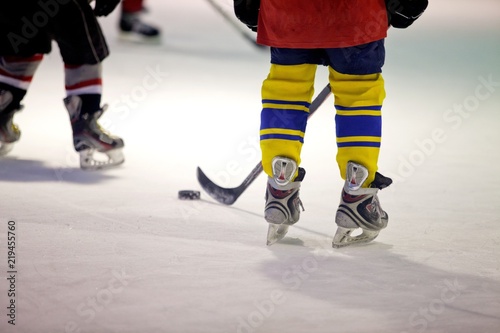 Closeup of Child Legs in Ice Hockey in Arena