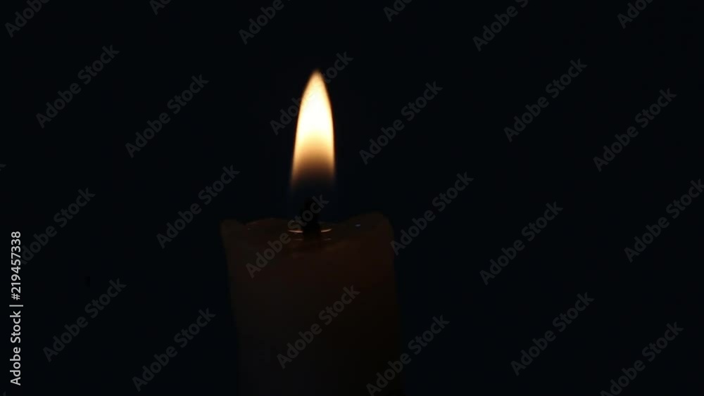 Candle burns and rotates on a black background Candle burns and rotates on a black background