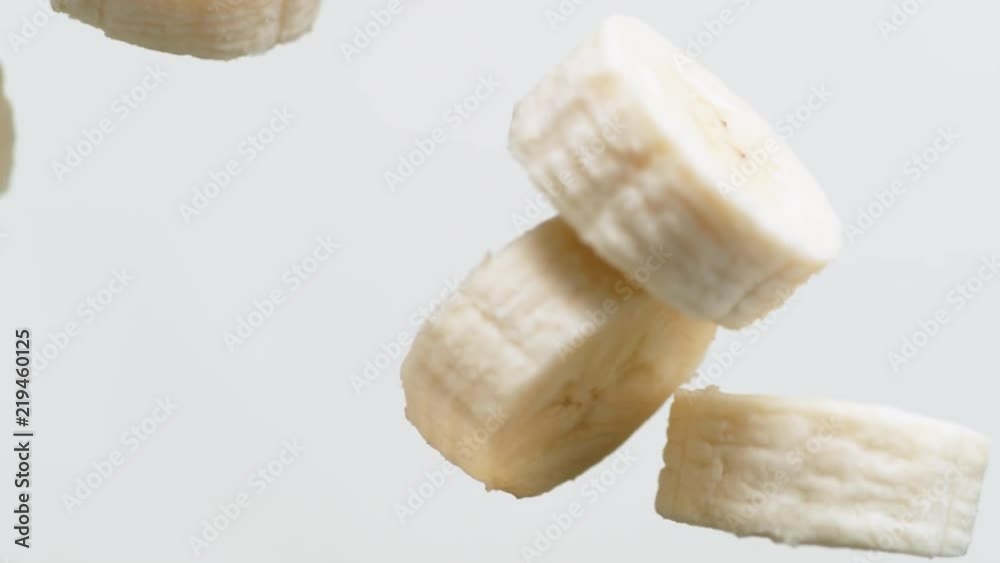 Camera follows tossing sliced banana in milk . Overhead shot. Shot with high speed camera, phantom flex 4K. Slow Motion. Camera follows tossing sliced banana in milk . Overhead shot. Shot with high speed camera, phantom flex 4K. Slow Motion.