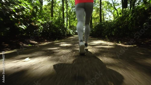Young girl jogging in the park, legs only, 4K