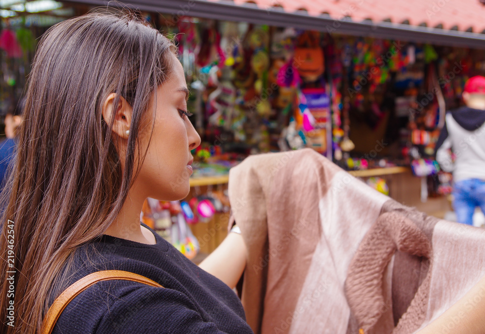 Obraz premium Close up of young woman holding in her hands a handmade at a craft store in the Passage Craft in the downtown of the city of Banos