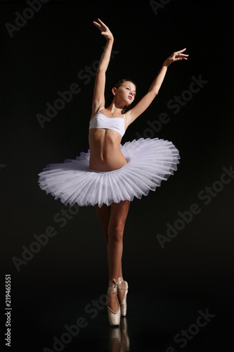 A young ballerina in a ballet tutu and on pointe