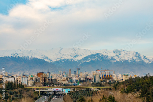 Islamic Republic of Iran. Tehran. City center and mountainous background. Freeway with flags. 02 March 2018