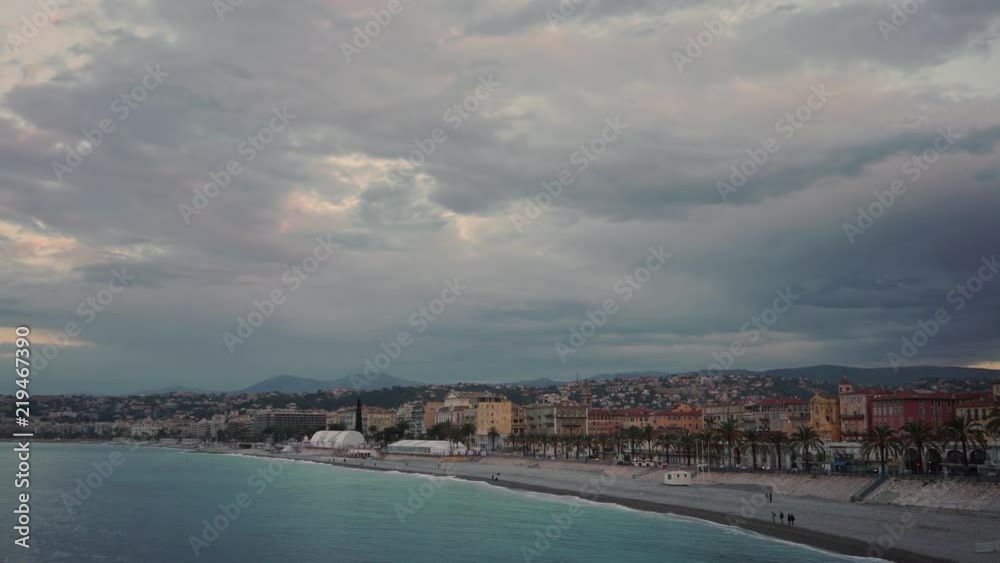 Sunrise in French city of Nice with a beautiful coastline and luxury houses. A calm sea. Concept of tourism. Right to left pan real time establishing shot Sunrise in French city of Nice with a beautiful coastline and luxury houses. A calm sea. Concept of tourism. Right to left pan real time establishing shot