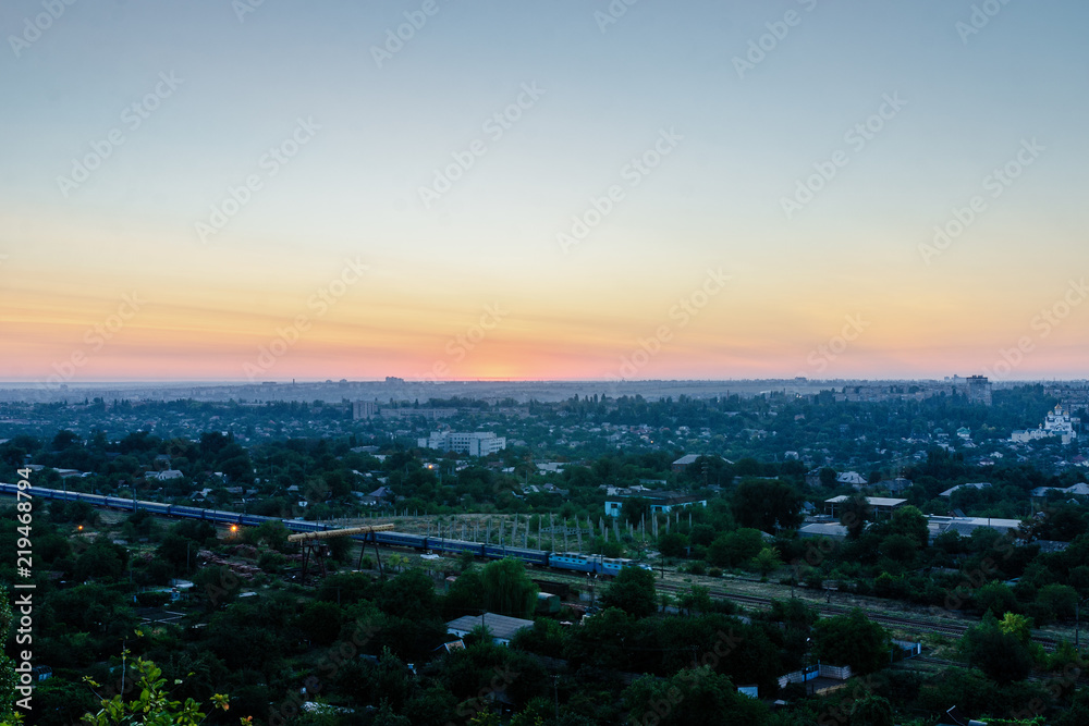 Fototapeta premium The train goes early in the morning around the city.