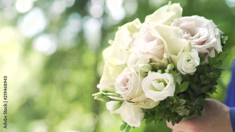 bridegroom is carrying a wedding bouquet stedy shot. The guy is carrying a bouquet. The bride is carrying a wedding bouquet. bridegroom is carrying a wedding bouquet stedy shot. The guy is carrying a bouquet. The bride is carrying a wedding bouquet.