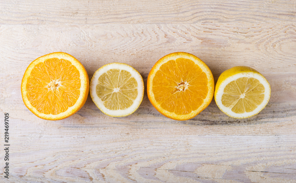 Fresh oranges and lemons on a wooden background Fresh oranges and lemons on a wooden background