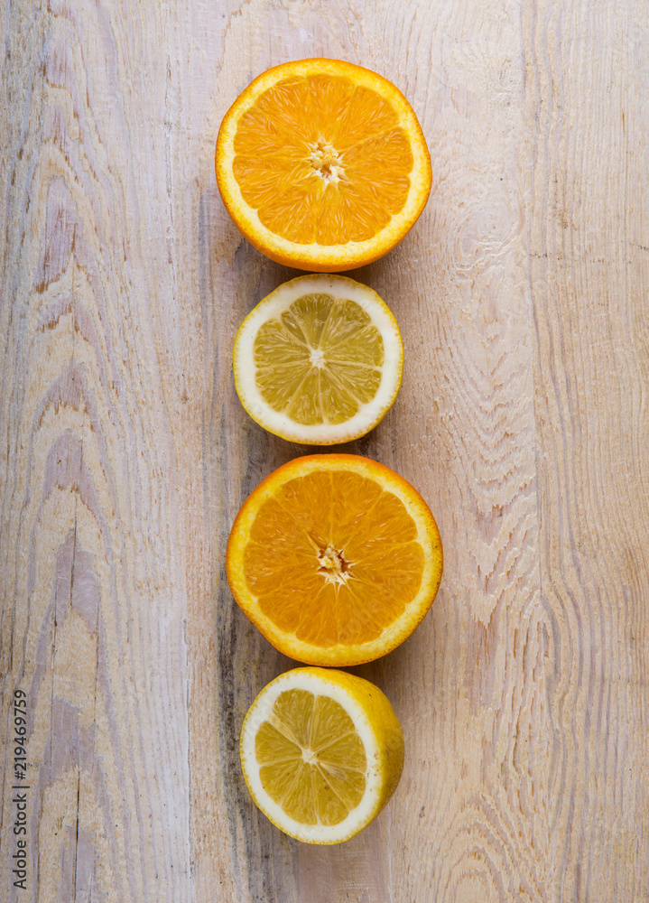 Fresh oranges and lemons on a wooden background Fresh oranges and lemons on a wooden background