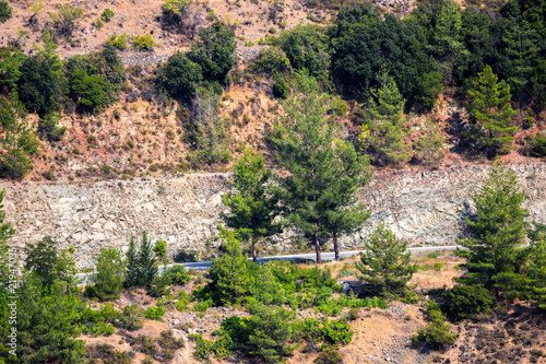 Mountain slopes with trees, terrases and roads in the Troodos region of Cyprus in summer photo