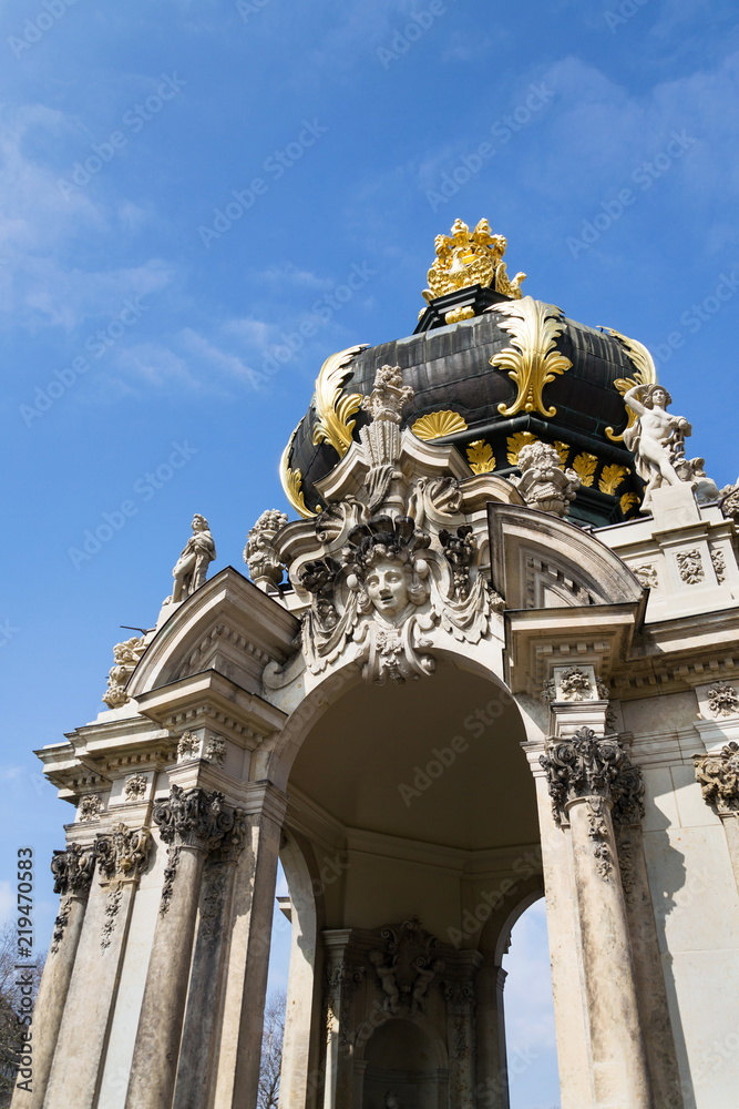 Meeting point Kronentor, crown gate detail at baroque Zwinger palace in Dresden, Germany, sunny day blue sky background