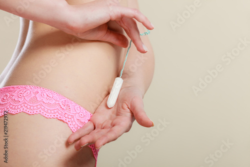 Girl holding tampon during the monthly cycle © anetlanda