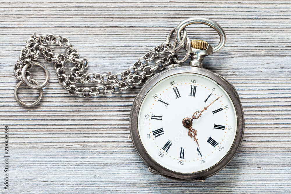 retro pocket watch with chain on gray table retro pocket watch with chain on gray table