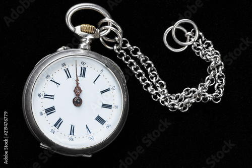 retro pocket watch with chain on black velvet