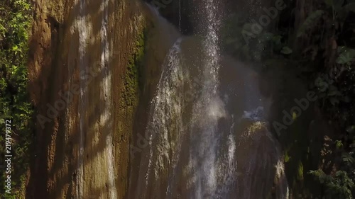 Descending aerial, scenic waterfall in woods photo