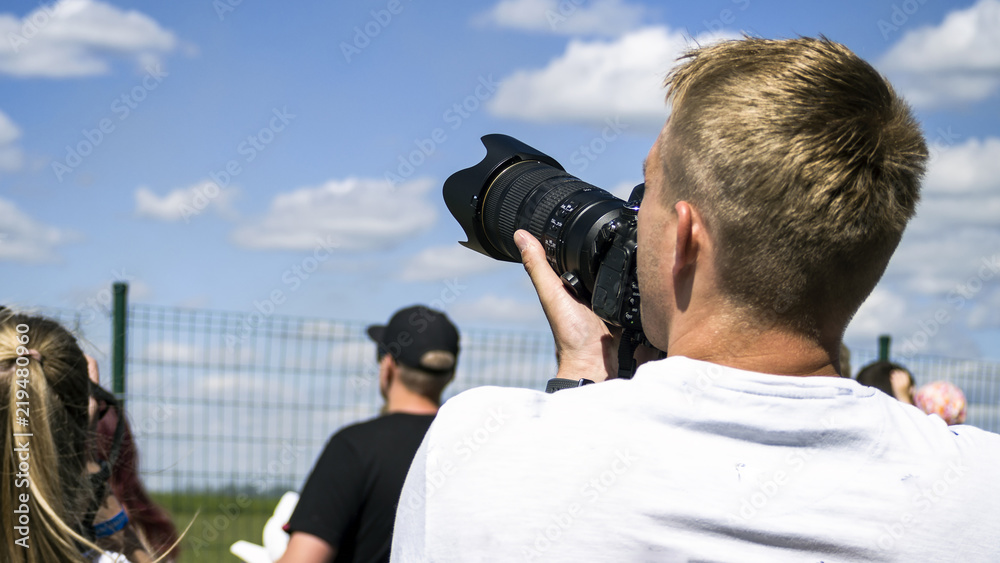 photographer holding a camera photographer holding a camera