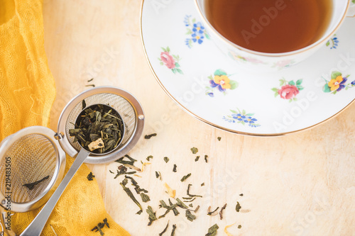 Crown Staffordshire Fine Bone China Loose Leaf Green Tea in Spoon and Diffuser on Yellow Background