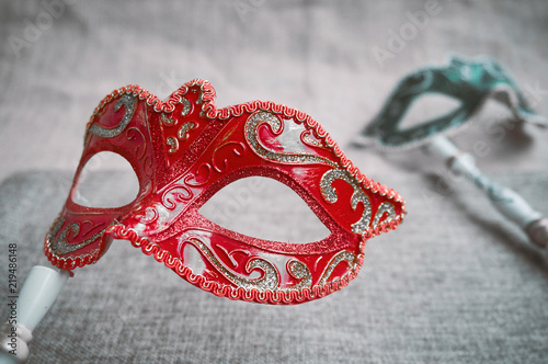 Close up, Selective focus on red venetian masquerade, carnival mask with blurry green mask background
