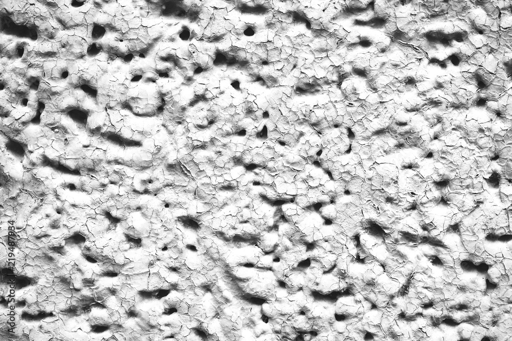 Detailed imperfect white texture of aerated foam block with holes close-up. Side of building is painted whitish. Background of construction from foamed material in macro. Decorative facing of house. Detailed imperfect white texture of aerated foam block with holes close-up. Side of building is painted whitish. Background of construction from foamed material in macro. Decorative facing of house.