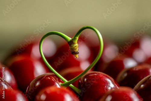 red cherries with a stalk in heart shape