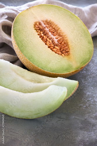 Sliced Cantaloupe melone on dark photo