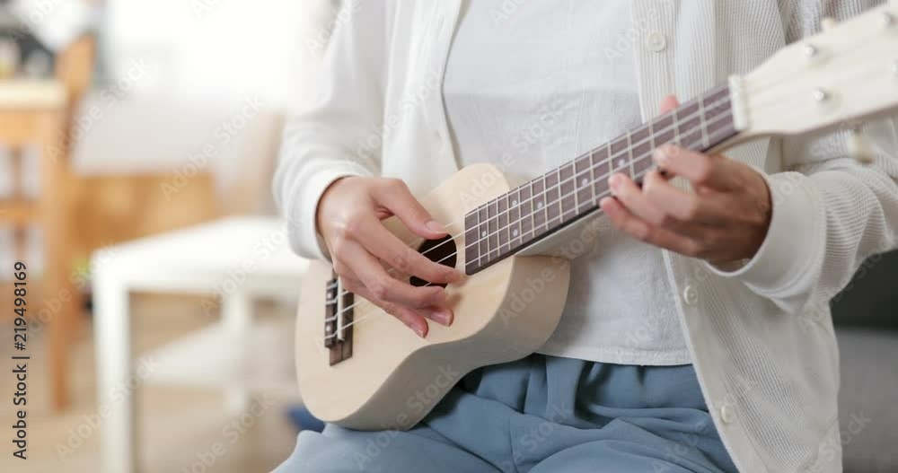 Woman playing ukulele Woman playing ukulele