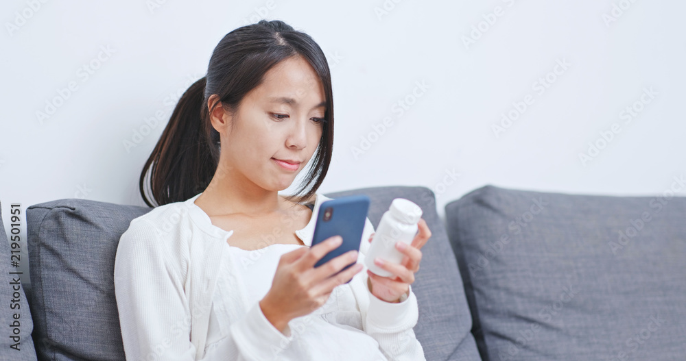 Woman checking the ingredient and bottle of drug Woman checking the ingredient and bottle of drug