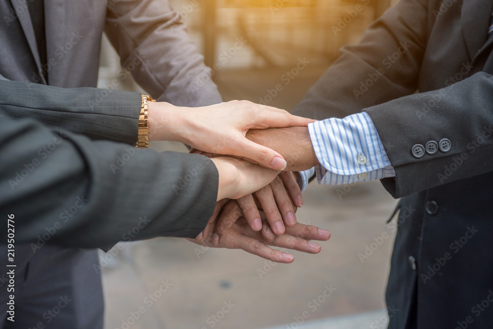 Close-Up of hands business team showing unity with putting their hands together.