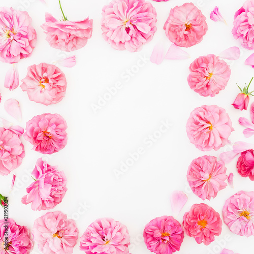 Pastel pink roses and petals on white background. Flat lay  top view. Flower frame of pink flowers