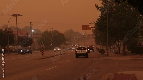 A busy highway is engulfed by a thick haze of smoke from nearby bc forest fires. Camera focus pulls into heavy bokeh effect.