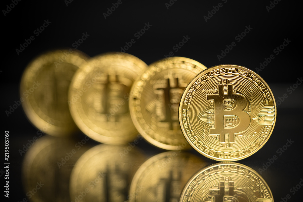 Row of bitcoins in physical form with black background Row of bitcoins in physical form with black background