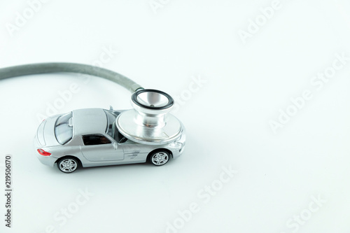 Stethoscope checking up the car on white background, Concept of car check up, repair and maintenance..