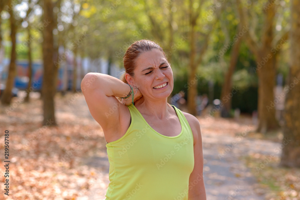 Mature woman holding her neck