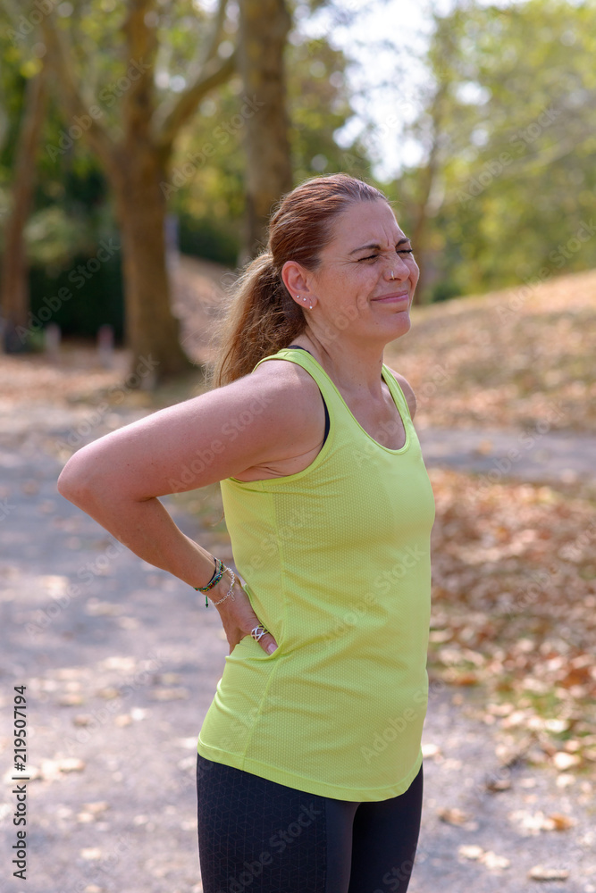 Middle aged woman out jogging suffers a muscle injury Middle aged woman out jogging suffers a muscle injury