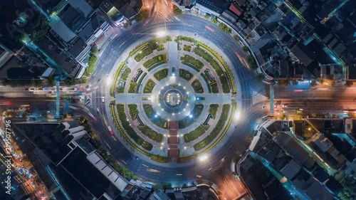 timelapse of night city traffic on 4-way stop street intersection circle roundabout in bangkok, thailand. 4K UHD horizontal aerial view.