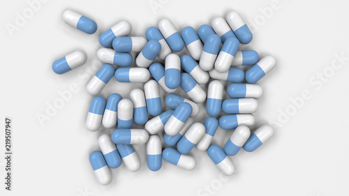 Pile of white and blue medicine capsules