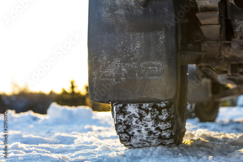 Four wheel drive car splash guard in Finland. In the background a snowy and sunny landscape.