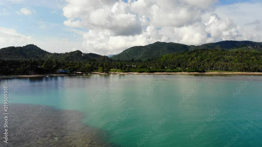Aerial view of tropical sea and beach on white cloud and blue sky