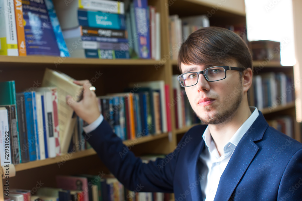Belarus, Gomel, September 19, 2017. The main library. The day of open doors. An intimate man with glasses in the library. Student in the library Belarus, Gomel, September 19, 2017. The main library. The day of open doors. An intimate man with glasses in the library. Student in the library