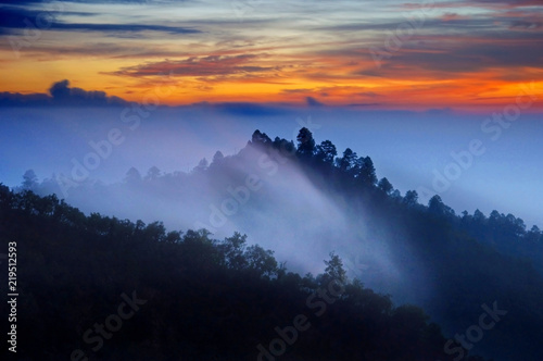 Mountain and winter fog in morning time, before sunrise twilight color sky. Doi Ang Khang Thailand.