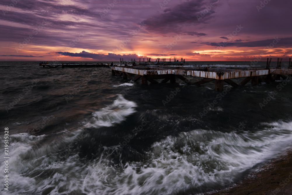 Building incomplete in the sea with sunset sky Building incomplete in the sea with sunset sky