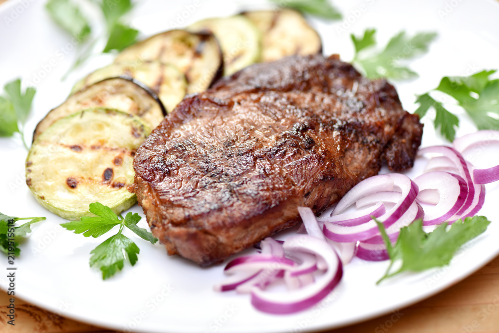 Meat cooked on a grill. Fried beef steak. Healthy food. Restaurant main course.
