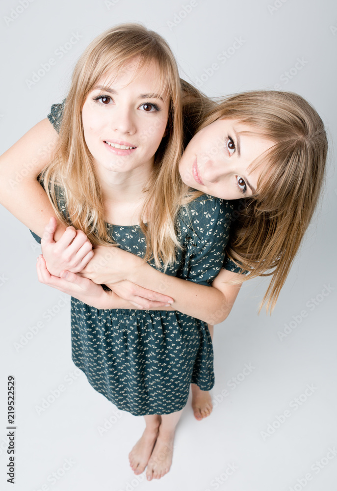 Beautiful two twins sisters together . Close-up beauty portrait Beautiful two twins sisters together . Close-up beauty portrait