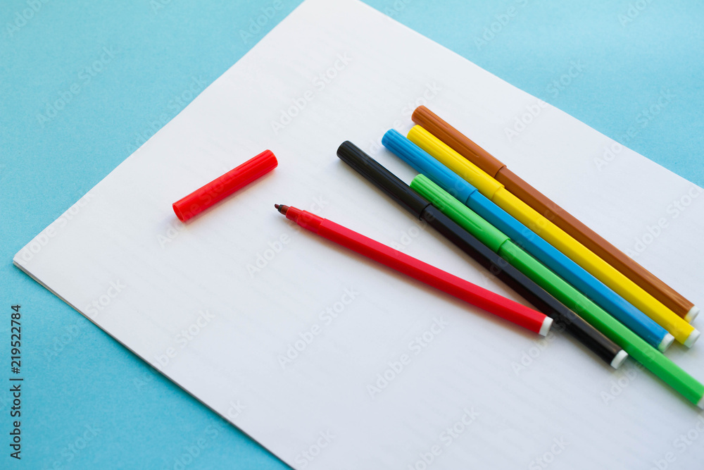 colored pens, pencils on a blue background. day of knowledge colored pens, pencils on a blue background. day of knowledge