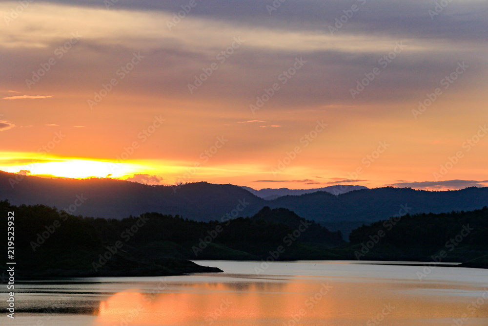Beautiful sunset in the lake with layers of the mountain.