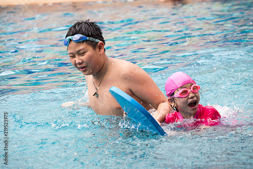 Two happy kids in a swimming pool
