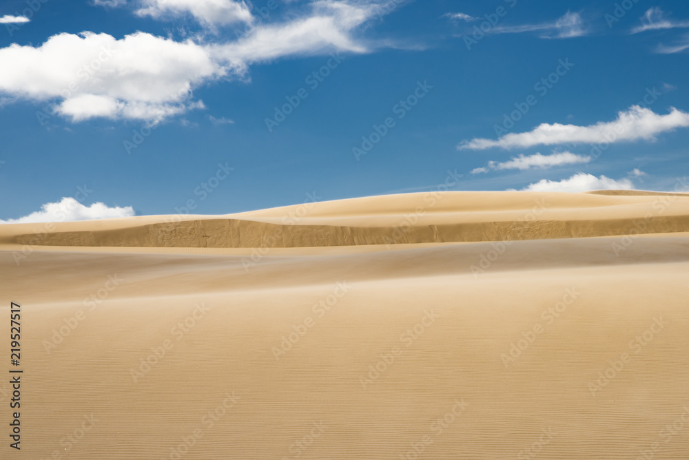 sand dunes against blue sky and clouds in Leba, Poland,