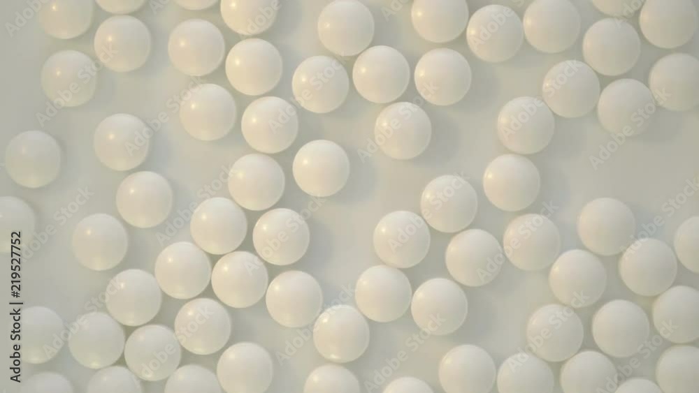 Pile of white pills on a plate turning around top view Pile of white pills on a plate turning around top view